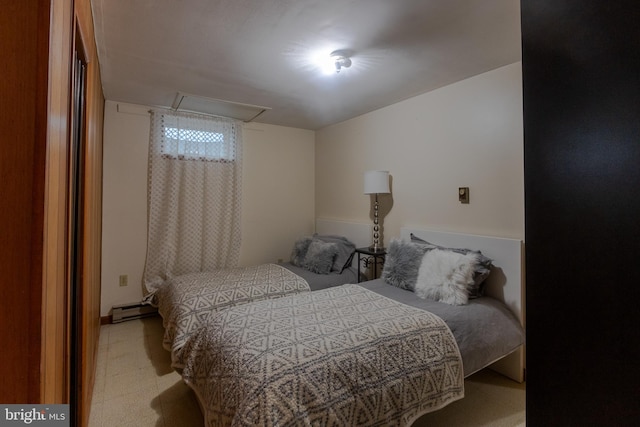 bedroom with light carpet and baseboard heating