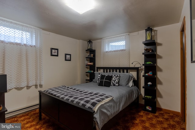 bedroom featuring dark colored carpet and multiple windows