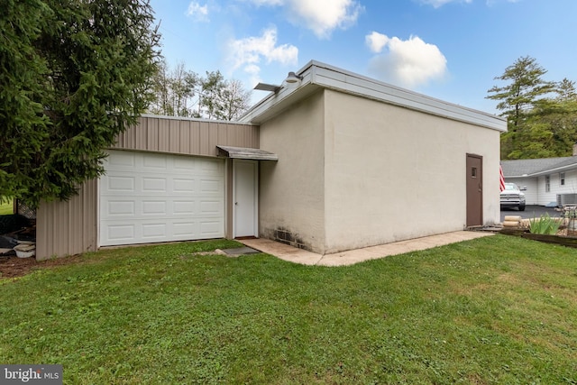 view of property exterior featuring a garage and a yard