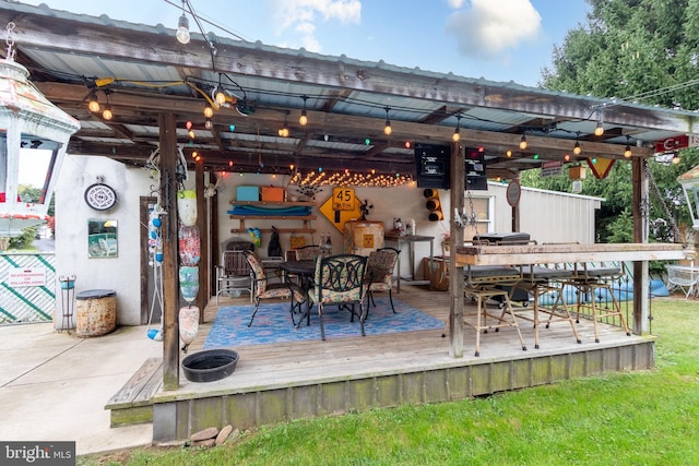 deck featuring an outdoor bar and a yard