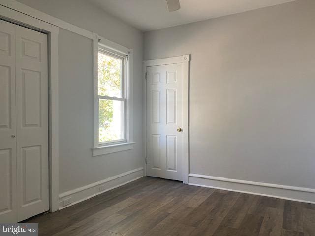 unfurnished bedroom with ceiling fan and dark hardwood / wood-style floors