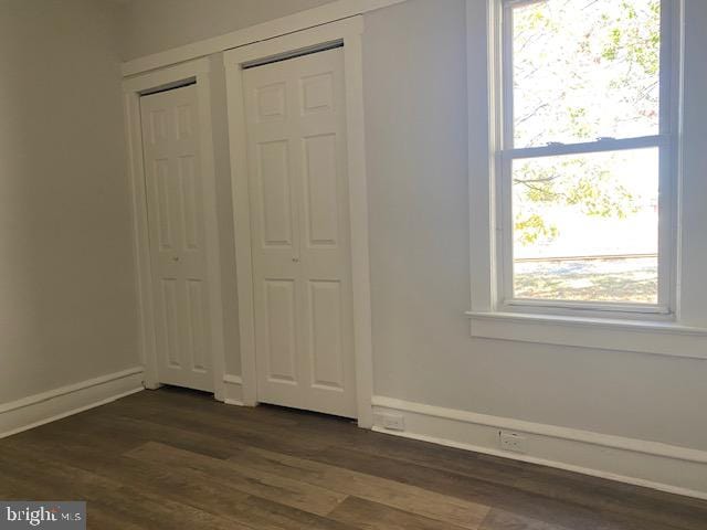 unfurnished bedroom with dark hardwood / wood-style floors