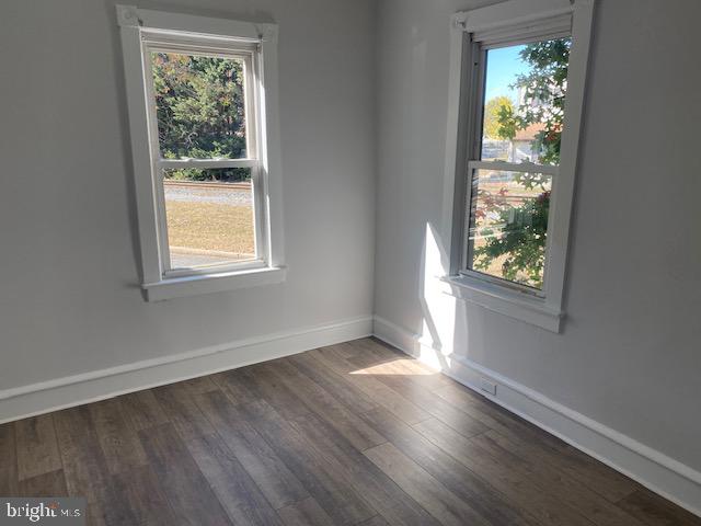 empty room with dark wood-type flooring