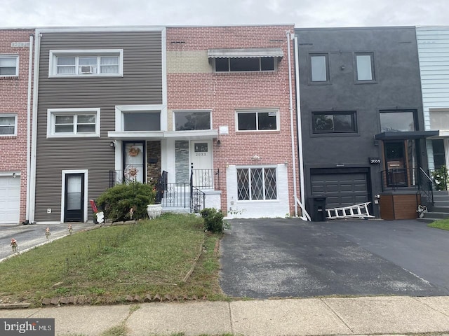 multi unit property featuring a garage