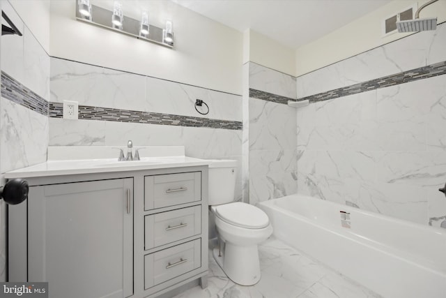 full bathroom featuring tiled shower / bath, vanity, and toilet