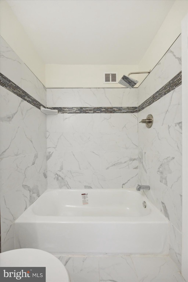 full bath with visible vents, toilet, and shower / washtub combination