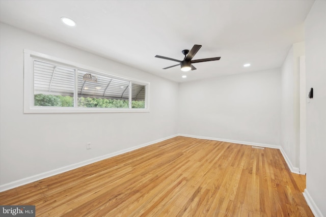 spare room with light wood-type flooring and ceiling fan