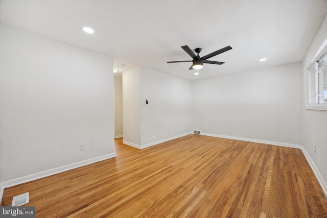 empty room featuring ceiling fan, light wood-type flooring, visible vents, recessed lighting, and baseboards