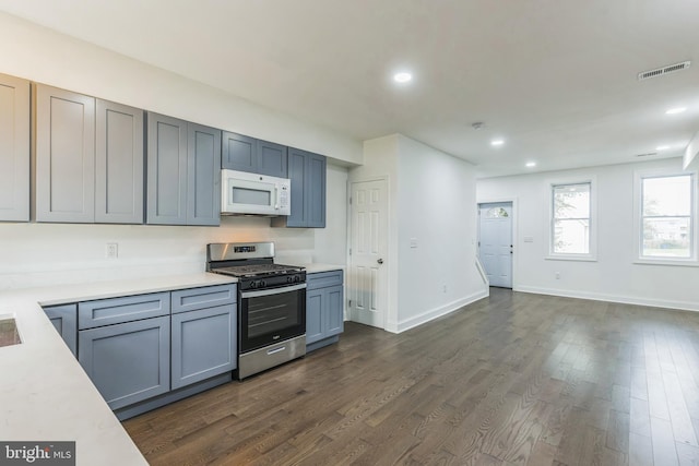 kitchen with dark wood-type flooring and gas stove