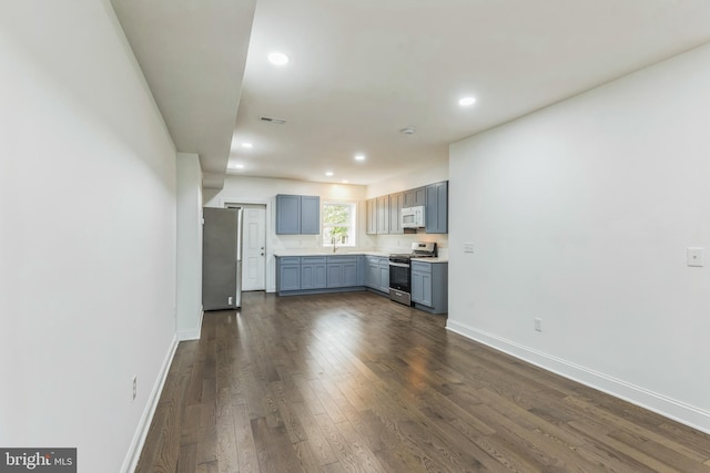 kitchen with stainless steel appliances, dark hardwood / wood-style floors, and sink