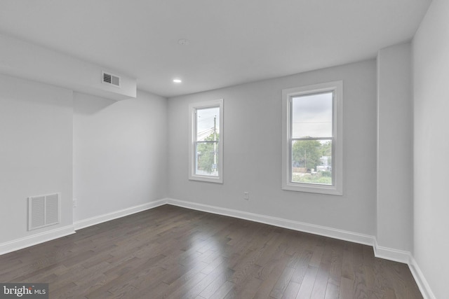 spare room with dark hardwood / wood-style flooring