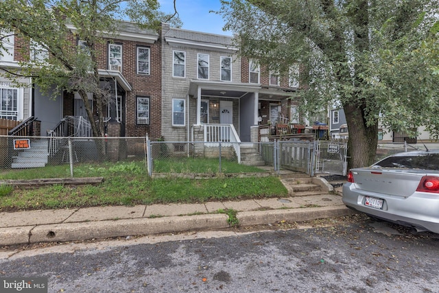 townhome / multi-family property featuring a porch