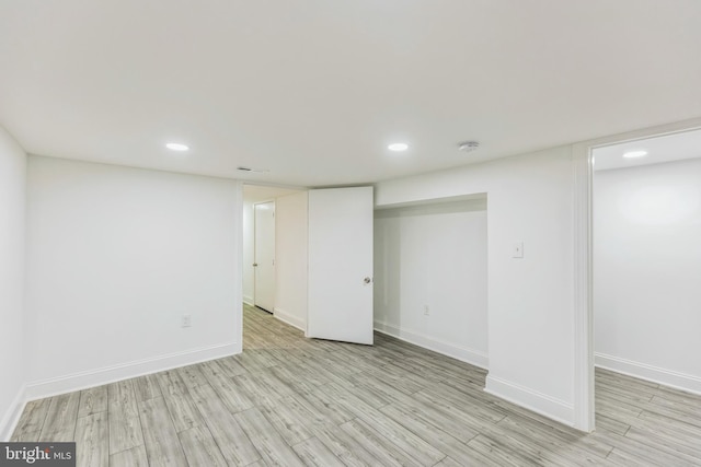 basement with light hardwood / wood-style floors