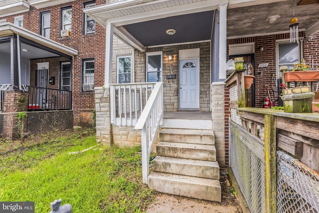 property entrance with cooling unit and a porch