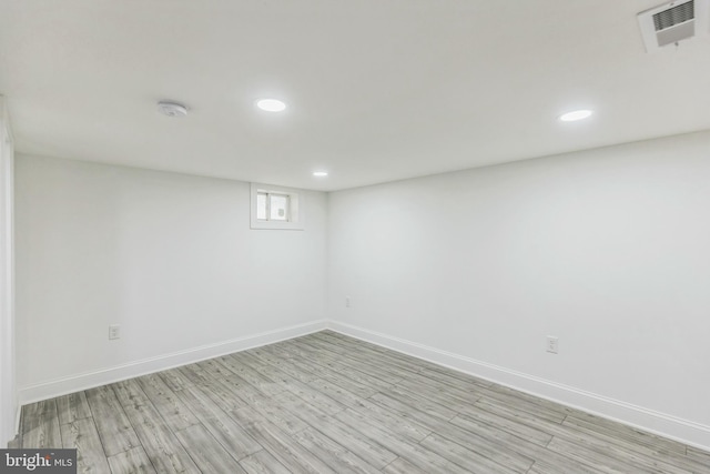 basement with light hardwood / wood-style flooring