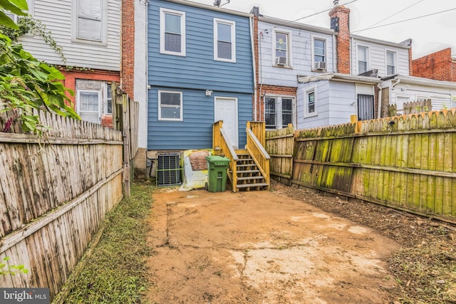 back of property featuring cooling unit and central AC unit