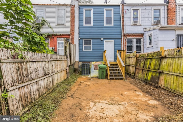 back of property featuring cooling unit and central AC