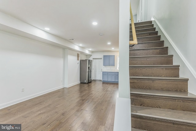 staircase with hardwood / wood-style floors