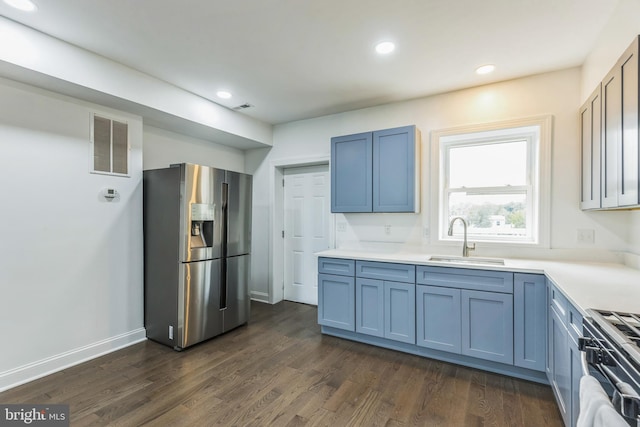 kitchen with stainless steel appliances, blue cabinets, dark wood-type flooring, and sink