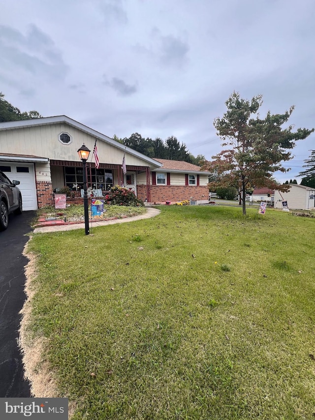 view of front of property with a front yard and a garage