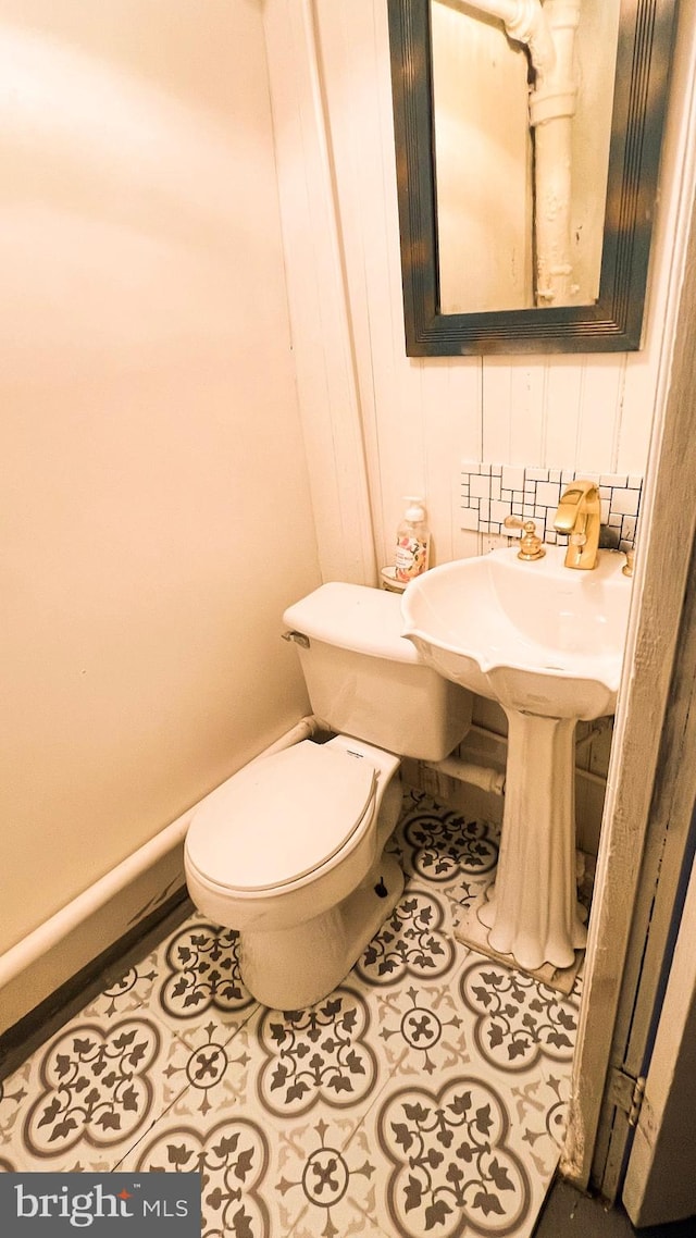 bathroom featuring tile patterned flooring and toilet