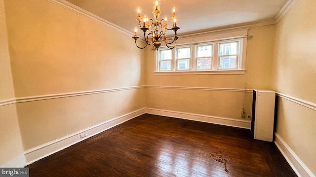 unfurnished room with an inviting chandelier, ornamental molding, and dark hardwood / wood-style floors