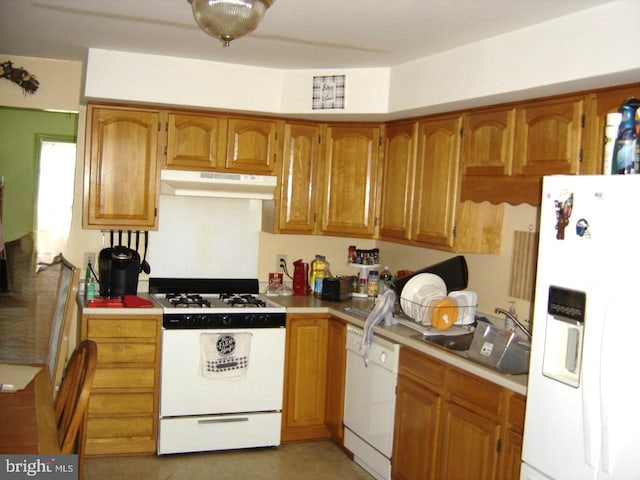 kitchen featuring white appliances and sink