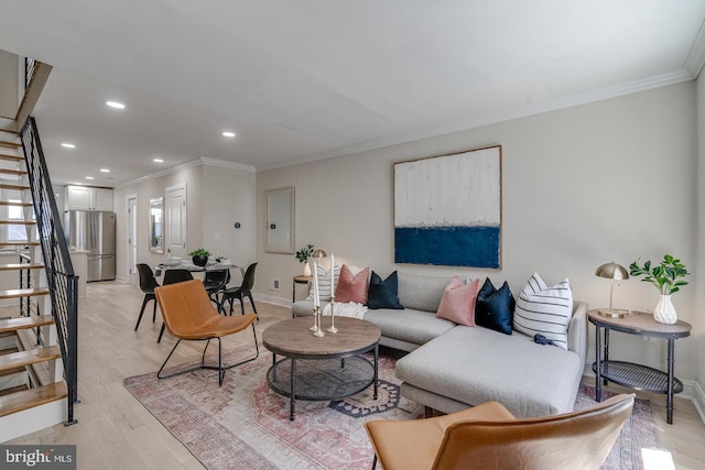 living room with crown molding and light wood-type flooring