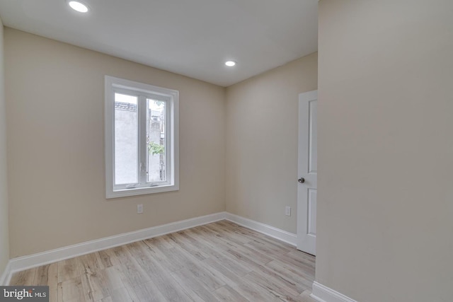 spare room with light hardwood / wood-style flooring