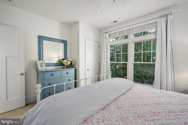 bedroom with ceiling fan and light colored carpet