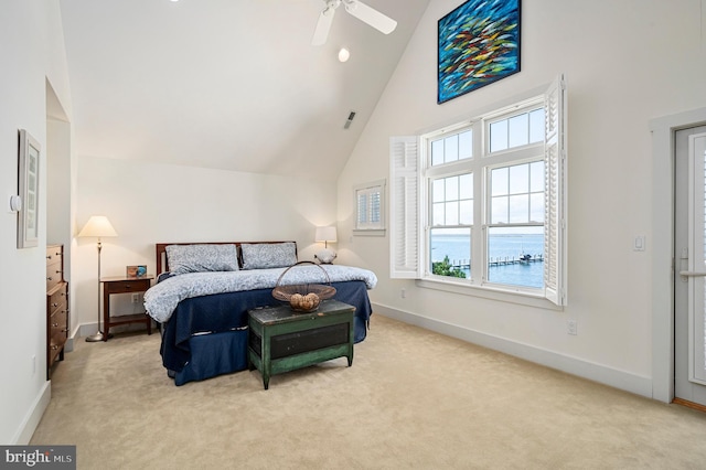 carpeted bedroom with ceiling fan, a water view, and high vaulted ceiling