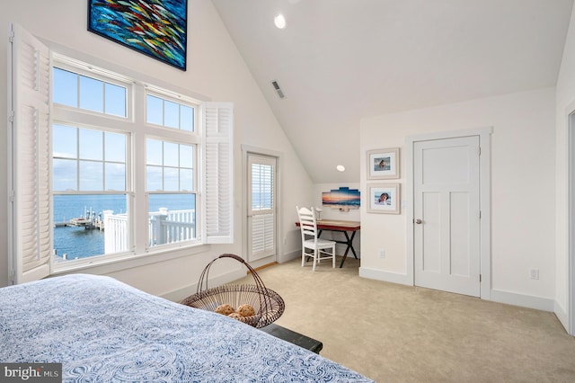 carpeted bedroom featuring a water view and lofted ceiling