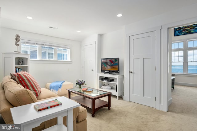 living room with a healthy amount of sunlight and light colored carpet