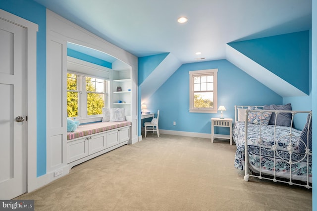 bedroom with light carpet and vaulted ceiling