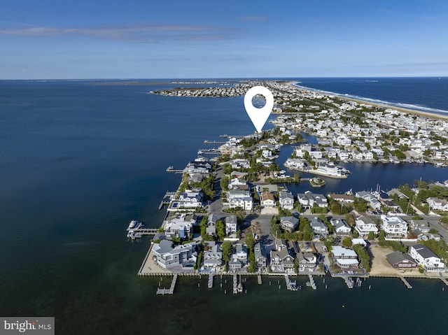 birds eye view of property with a water view and a view of the beach