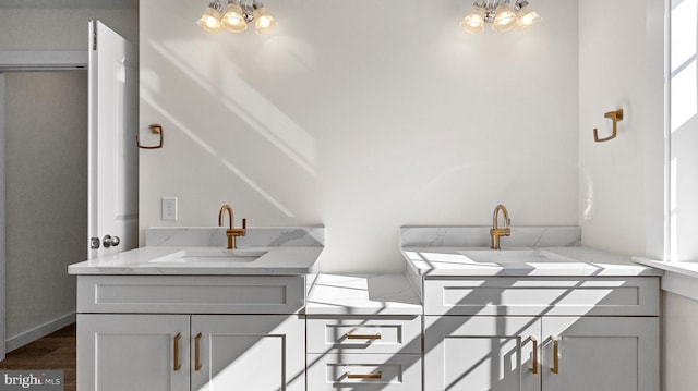 bathroom with sink and a chandelier