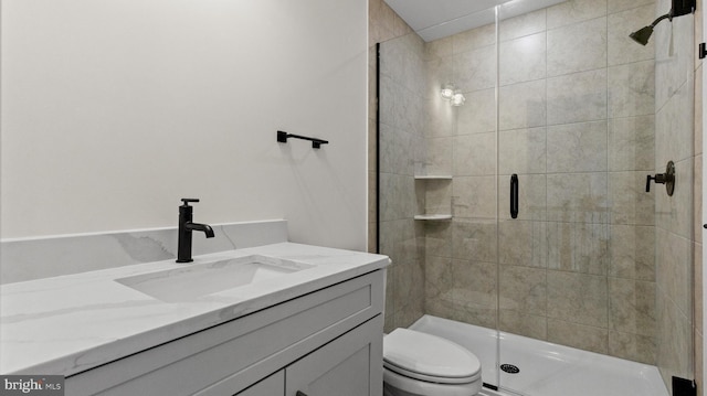 bathroom with vanity, toilet, and an enclosed shower