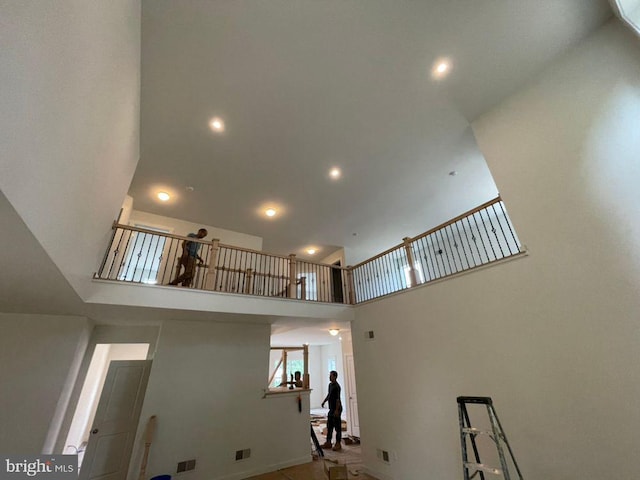 interior space featuring tile patterned flooring and a high ceiling