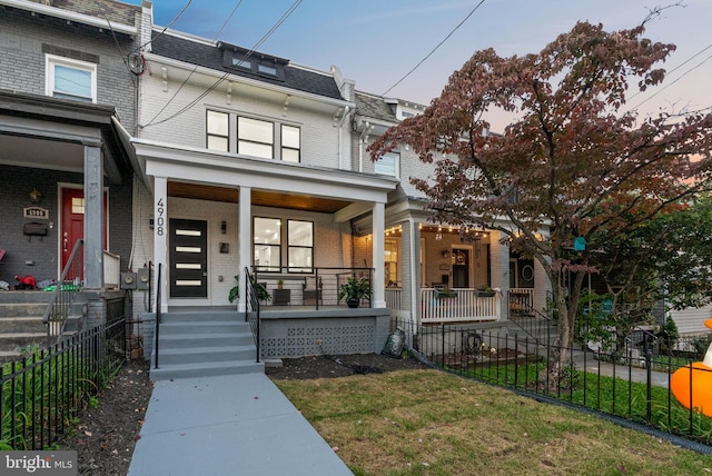 view of front facade with a yard and covered porch