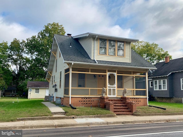 view of front of house with a porch and a front yard