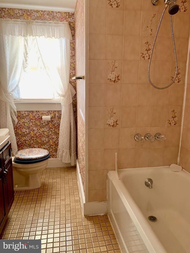 full bathroom with tile patterned floors, toilet, vanity, and tiled shower / bath combo