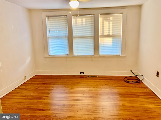 empty room featuring ceiling fan and light hardwood / wood-style floors