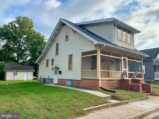 view of front of property with central AC unit, a front lawn, and covered porch