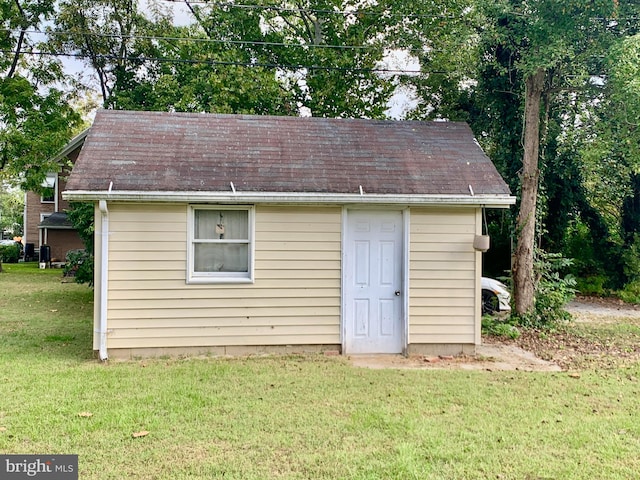 view of outbuilding with a yard