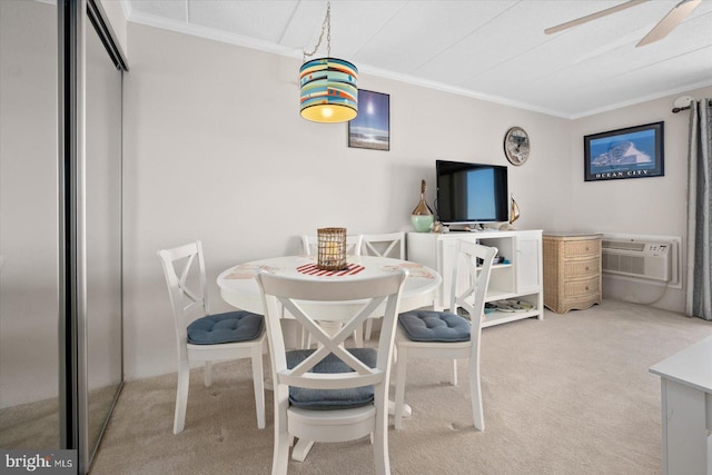 carpeted dining space with an AC wall unit, crown molding, and ceiling fan