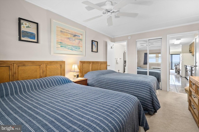 bedroom with a closet, ceiling fan, crown molding, and light colored carpet