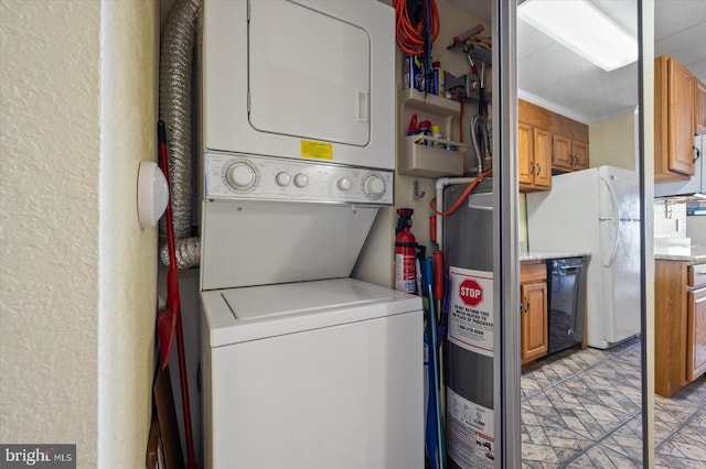 washroom with ornamental molding, electric water heater, and stacked washer / dryer