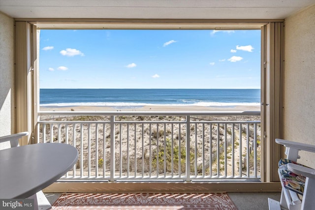 balcony with a view of the beach and a water view