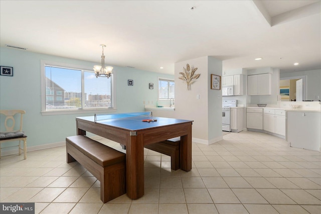 tiled dining space featuring an inviting chandelier