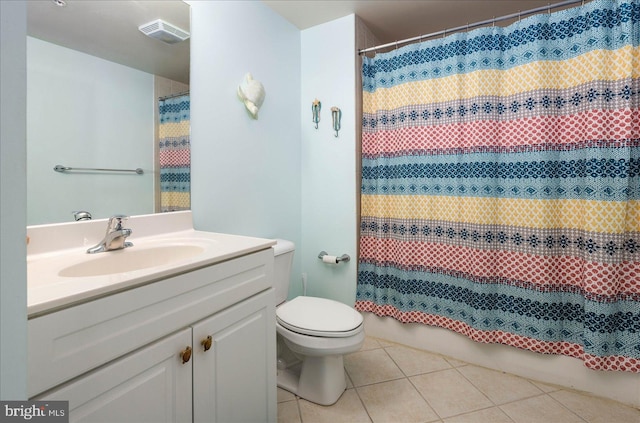 bathroom with tile patterned floors, vanity, and toilet